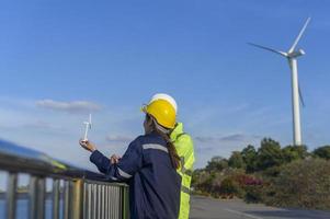 people engineer are wearing a protective helmet on head, using tablet Analytics engineering data. photo