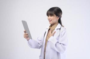 Young female doctor with stethoscope over white background photo