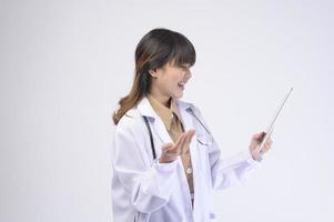 Young female doctor with stethoscope over white background photo