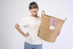 Young beautiful housewife smiling on white background photo