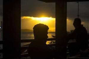 The Silhouette of men on the fishing pier photo