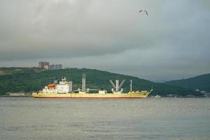 Vladivostok, Russia-July 12, 2020-Seascape with ships on the background of the city. photo