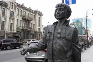 Vladivostok, Russia-December 11, 2018-Urban landscape with a sculpture of a man. photo