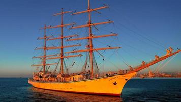 An old sailboat at sunset on the background of the sea. photo