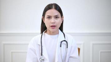 Female doctor making video call on social network with patient consulting about health problems