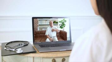 Female doctor making video call on social network with patient consulting about health problems