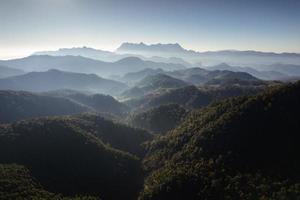 Scenery of Doi Luang Chiang Dao with mountain layer and fog on sunny day in tropical rainforest at national park photo