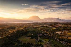 Sunrise shining on Doi Luang Chiang Dao mountain with fog in farmland at countryside at Chiang Dao photo