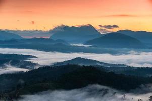 Sunrise over Doi Luang Chiang Dao mountain and foggy on hill in national park at Den TV viewpoint photo