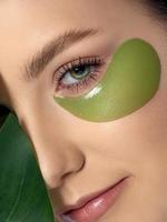 Woman with green eye patches under her eyes photo