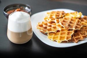 Excellent breakfast Viennese Belgian waffles apple jam and a mug of hot cappuccino photo