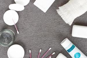 Soap, towel, toothpaste, cream on a gray background. Hygiene products. photo