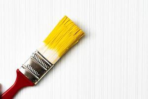 Red brush on a light textured background close-up photo