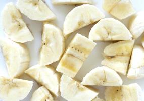 banana cut into pieces on a white background. Fruit background photo