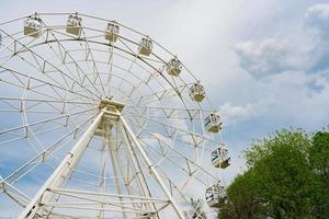 Ferris wheel in the park against the blue sky. Sokolniki Amusement Park in Moscow