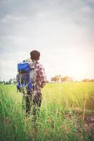 hombre hipster con una mochila sobre los hombros, hora de viajar, concepto de turismo. foto