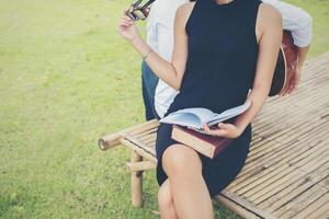 Young education couple was reading in the outdoors and good weather. And they're happy, Lifestyle concept. photo