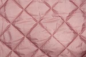 Photo of the texture of pink quilted fabric