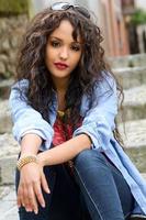 Attractive mixed woman in urban background wearing casual clothes photo