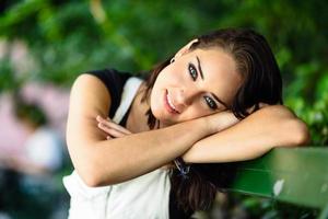 Happy young woman with blue eyes looking at camera photo