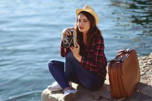 Woman taking photographs with a vintage camera photo