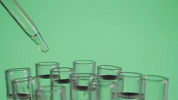 Close up of laboratory scientist working with a pipette analyzes and extract the DNA or molecules in the test tubes.on blur background with virtual interface video