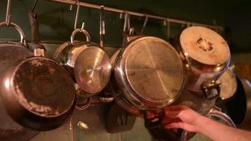 Many Pans in the Kitchen, a Man takes a Pan for Cooking video