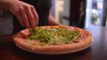 Hot Pizza just from Oven with Greens in Pizzeria Restaurant of Italian Kitchen video