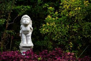 white Figurine of an angel stand and kiss in garden home on the day photo