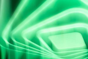 Abstract green glow of a bright LED lamp on the ceiling. Waves, squares and rhombuses. photo