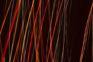 Bright multicolored diagonal and vertical lines of rays on. Abstract dark banner background. photo