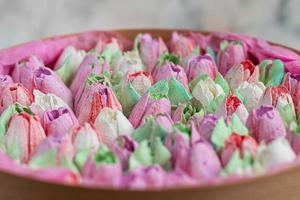 Handmade marshmallows in wooden packages on a light background with flowers. The concept of the holidays Women's Day and Valentine's Day.