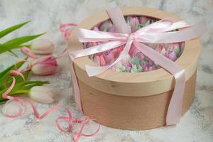 Handmade marshmallows in wooden packages on a light background with flowers. The concept of the holidays Women's Day and Valentine's Day. photo