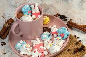 Marshmallow in the form of handmade animals on a light background. In a cup of coffee. Women's Day, Valentine's Day. photo
