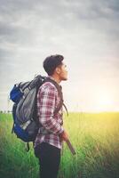 Hipster man with a backpack on his shoulders,time to go traveling,tourism concept. photo