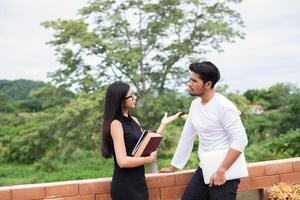 Young education couple talking about education after reading book,Relaxing with nature. photo