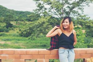 Portrait of young beautiful smiling woman outdoors.sunny day relaxing with nature fresh breeze. photo