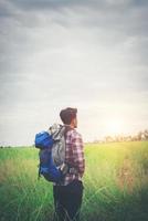 Hipster man with a backpack on his shoulders,time to go traveling,tourism concept. photo