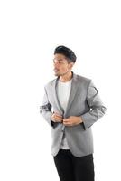 Portrait of young hipster man button up on gray suit  casual poses at studio. photo