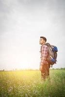 Hipster man with a backpack on his shoulders,time to go traveling,tourism concept. photo