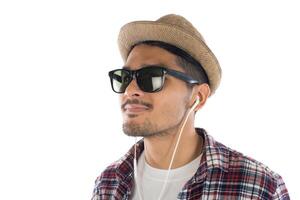 Young hipster man in earphones holding smartphone isolated on the white background. photo