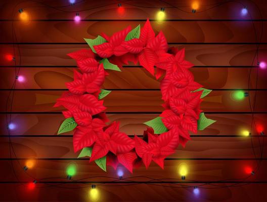 Christmas wreath ecoration with Poinsettia Euphorbia pulcherrima on wooden background