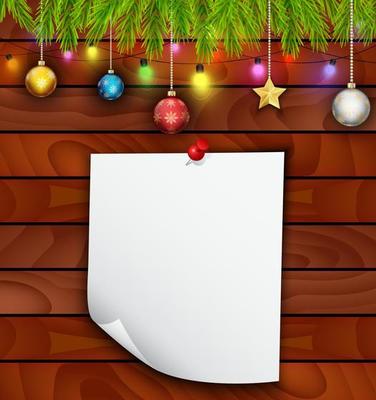 Planked wood with white paper and Christmas ornament