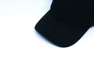 A Black Hat in The Corner of Minimalist White Background with Oblique Top Shot, Landscape Mode photo