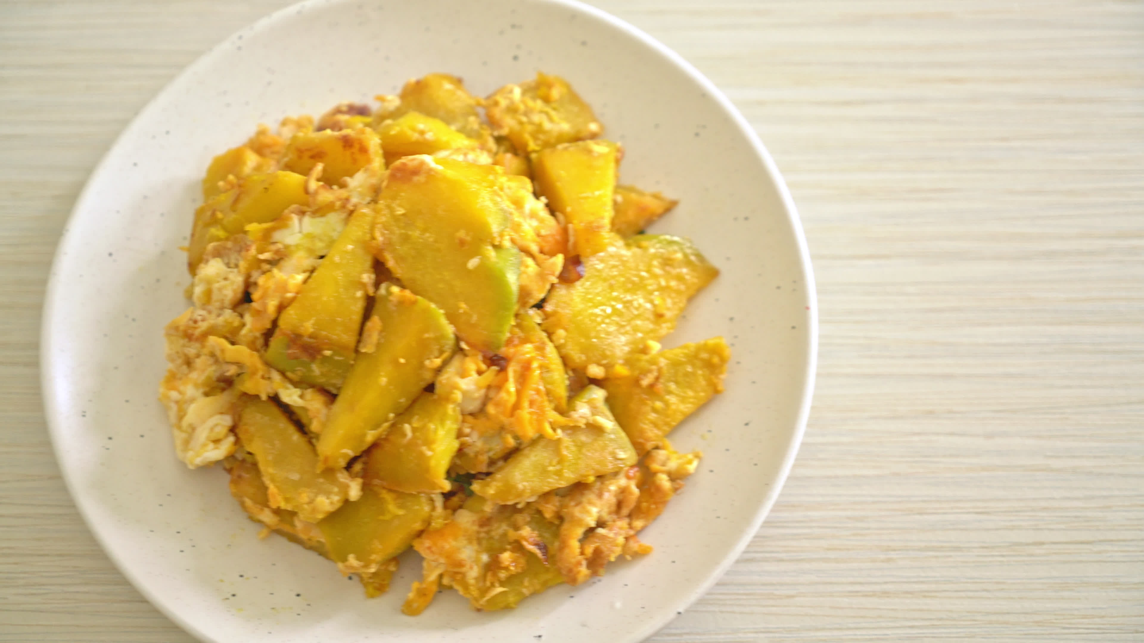 stirfried pumpkin with egg 5357429 Stock Video at Vecteezy