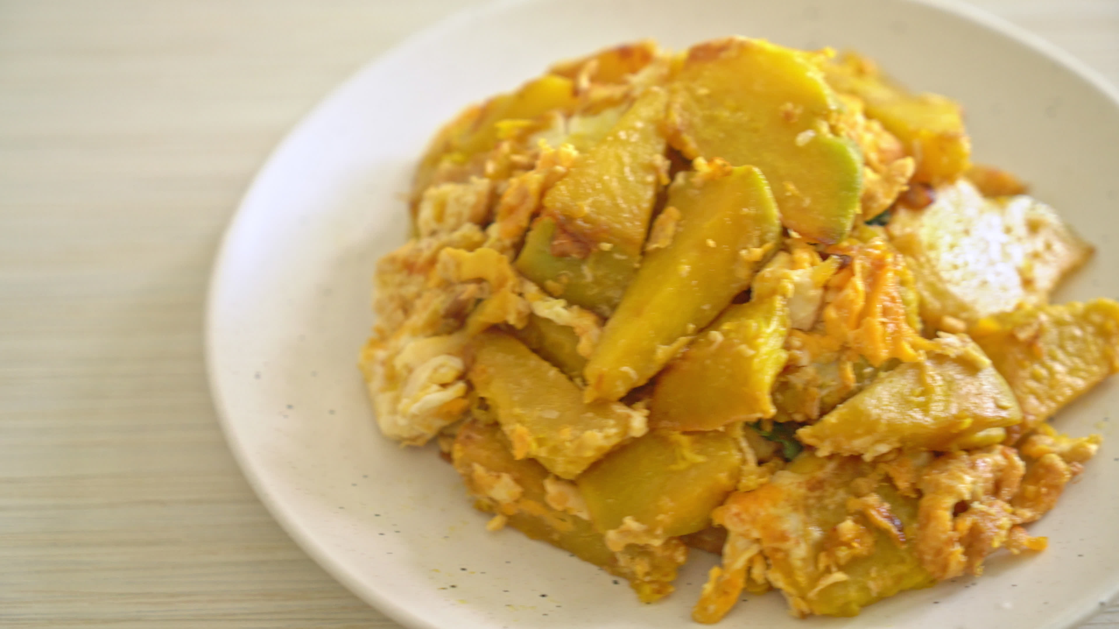 stirfried pumpkin with egg 5357443 Stock Video at Vecteezy