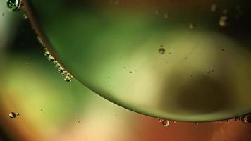 Abstract Colorful Food Oil Drops Bubbles and spheres Flowing on Water Surface, macro Videography video