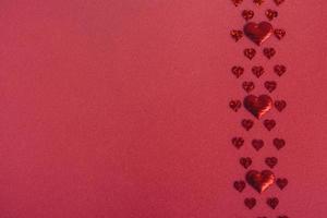 Valentines day background with red hearts on red background, flat lay, copy space photo