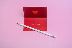 Valentines day greeting mockup with blank card and white pencil. Creative flat lay empty space. photo