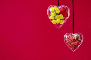 Transparent heart with yellow and burgundy roses in low poly style isolated on red background. Valentines day and mothers day concept, copy space photo